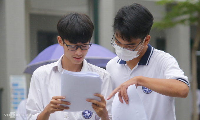 Hai thí sinh trao đổi sau khi kết thúc bài thi môn Ngoại ngữ, kỳ thi tốt nghiệp THPT 2022 tại điểm thi trường THCS Yên Hòa (Hà Nội), ngày 9/7. Ảnh: Thanh Hằng