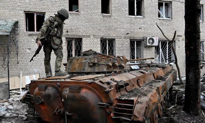 Tay súng Wagner trên xác xe chiến đấu bộ binh BMP-2 tại Bakhmut hôm 11/4. Ảnh: Ria Novosti