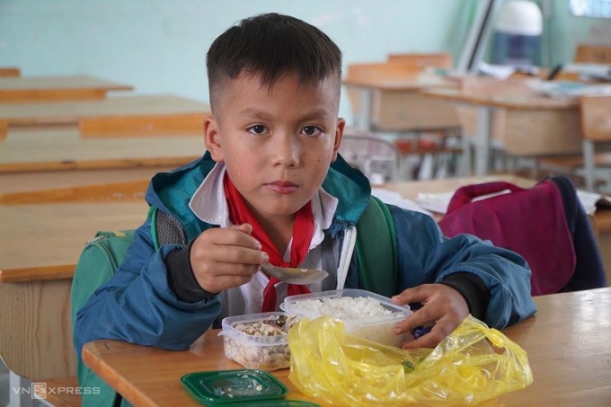 Học sinh trường Tiểu học tự mang cơm trưa đến lớp để ăn. Ảnh: Trần Hóa